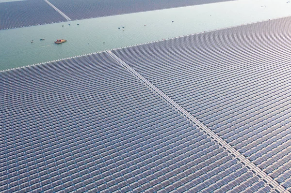 Aerial top view of solar panels or solar cells on buoy floating in lake sea or ocean. Power plant with water, renewable energy source. Eco technology for electric power in industry.