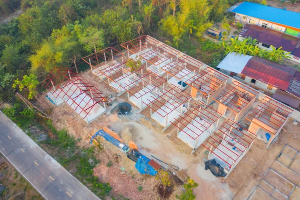 Aerial top view of homes or houses in village under construction site with structure. Top view of precast concrete slap floor. Development architecture buildings.