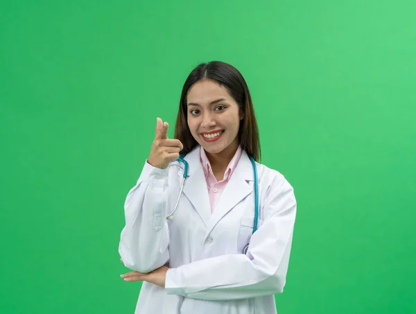 Young Asian doctor woman wearing doctor gown uniform coat and stethoscope isolated on green background, medical treatment. People