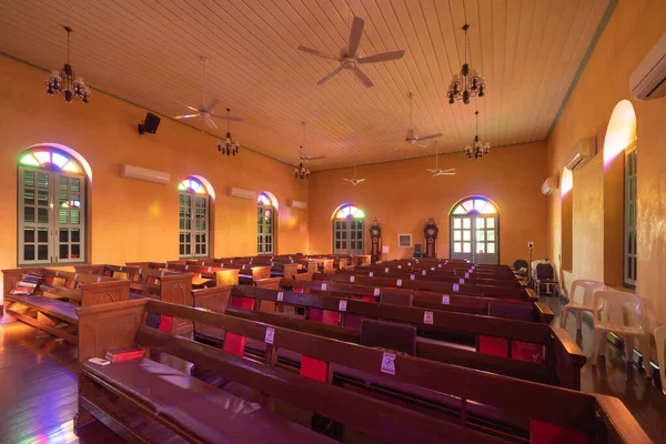 Interior of empty christian church with cross, architecture design. Religious beliefs. Catholic religion. Jesus worship.