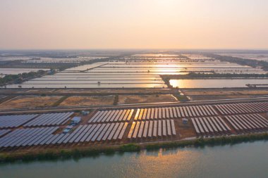 Çiftlikteki çatıdaki güneş panelleri veya güneş pillerinin havadan görüntüsü. Gölü ya da nehri olan elektrik santrali, Tayland 'da yenilenebilir enerji kaynağı. Endüstride elektrik gücü için eko teknoloji. Fotovoltaik hücreler