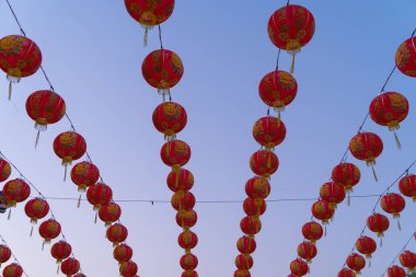 Çin Yeni Yıl Festivali kültürü üzerine Çin Mahallesi 'nin tapınağındaki açık hava lambalarında asılı kırmızı Çin fenerleri ve Asya' da gece karanlığında mavi gökyüzü..