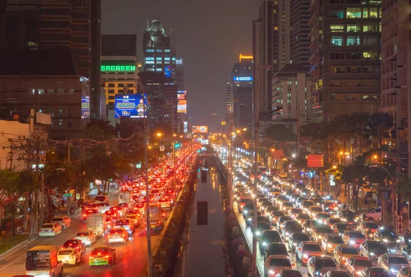 Crowd of busy cars with heavy traffic jam in rush hour on highway road street on bridge in Bangkok Downtown,urban city in Asia, Thailand. Intersection. Toll gate in Sathorn.Driving congestion at night