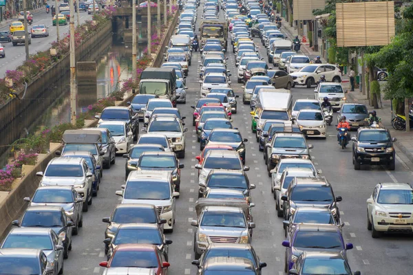 Crowd of busy cars with heavy traffic jam in rush hour on highway road street on bridge in Bangkok Downtown, urban city in Asia, Thailand. Intersection. Toll gate in Sathorn. driving congestion