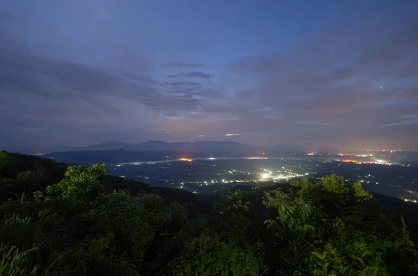 stock image Aerial top view of forest trees with fog mist and green mountain hill at night. Nature landscape background, Thailand.