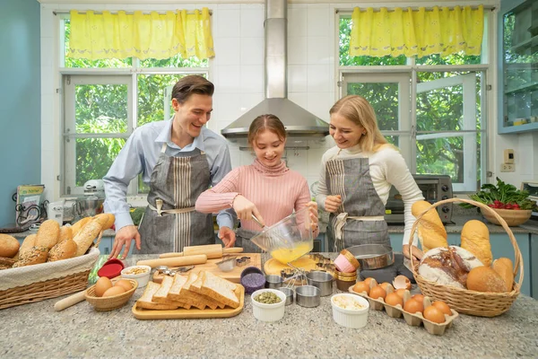 Portrait of happy western family cooking and baking breakfast, Food bread, toasts, dough together in kitchen at home or house, happy family homemade bakery. People activity lifestyle on weekend