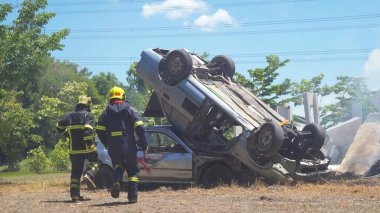Kurtarma ekibi bir kurbana yardım ediyor, yol kenarındaki araba kazasından insanların hayatını kurtarıyor. - İnsanlar. Kahraman. Hizmet işi.