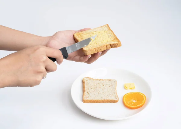 Mãos Espalhando Manteiga Uma Fatia Pão Isolado Fundo Branco Cozinhar — Fotografia de Stock