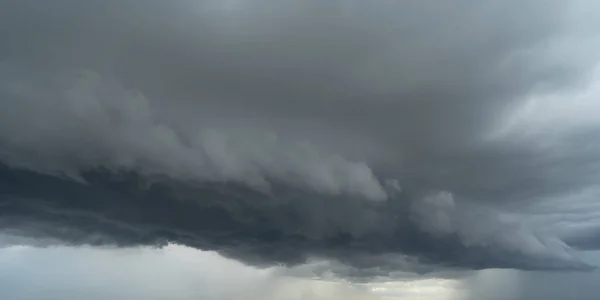 Dramatic dark clouds sky with thunder storm and rain. Abstract nature landscape background.