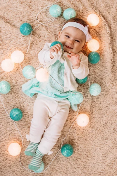 Adorable Smiling Little Girl Blue White Dress Playing Christmas Lights — Stock Photo, Image