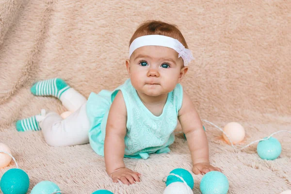 Cute Little Girl Beautiful Blue Eyes Blue Dress Sitting Beige — Stock Photo, Image