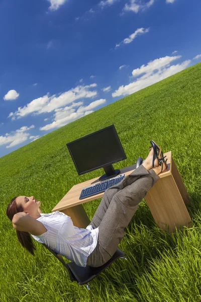 Woman Relaxing at Office Desk in Green Field — Stock Photo, Image