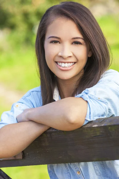 Beautiful Asian Eurasian Girl Resting on Fence Royalty Free Stock Photos