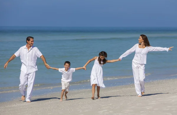 Μητέρα, ο πατέρας και τα παιδιά οικογενειακό τρέχοντας τη διασκέδαση στην παραλία — Φωτογραφία Αρχείου