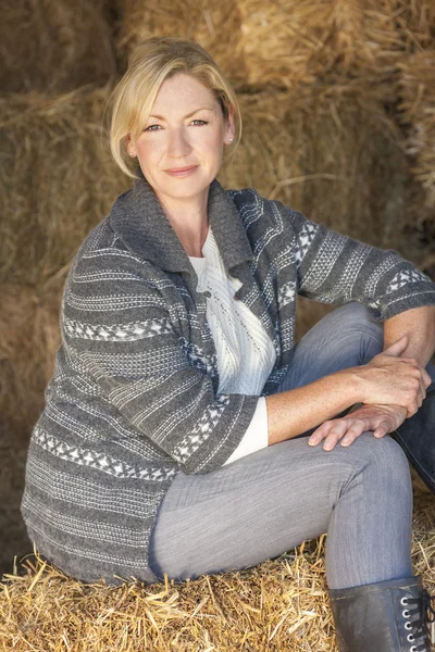 Middle Aged Blond Woman Sitting on Hay Bale — Stock Photo, Image