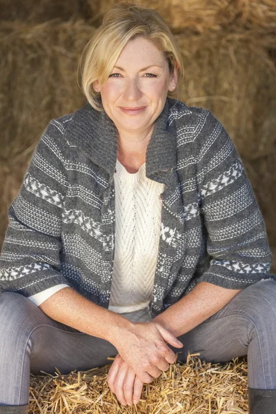 Middle Aged Blond Woman Sitting on Hay Bale — Stock Photo, Image