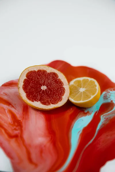 Meyve suyunda limonlu ang greyfurtun yarısı sulu sıvıyla aşağı akıyor.