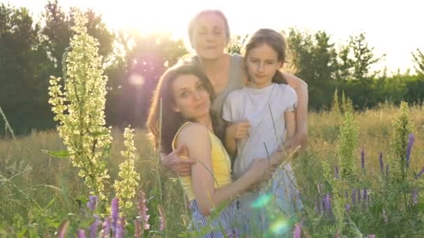 Söt flicka med sin unga mor och äldre mormor har picknick under sommaren utomhus i naturen, mödrar dag, glad pension, flera generationer familj — Stockvideo