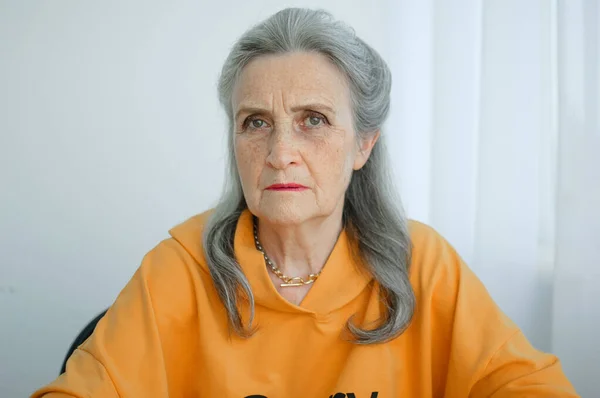 Closeup portrait of angry upset senior mature woman talking with someone and looking at the camera. Negative emotion, facial expression, scandal Stock Image