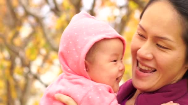 Happy asian chinese mother carrying her baby — Stock Video