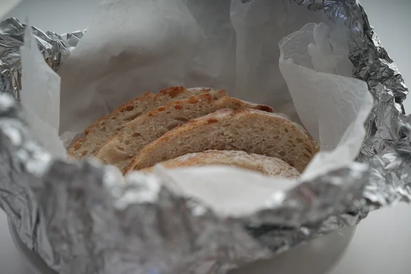 Bread served fresh covered in aluminium foil — Stock Photo, Image