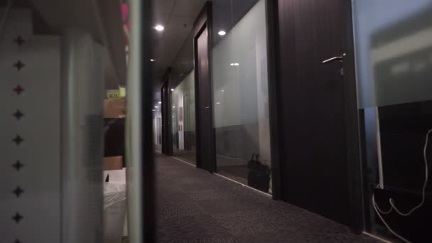 Dolly movement of a modern but empty dark office — Stock Video