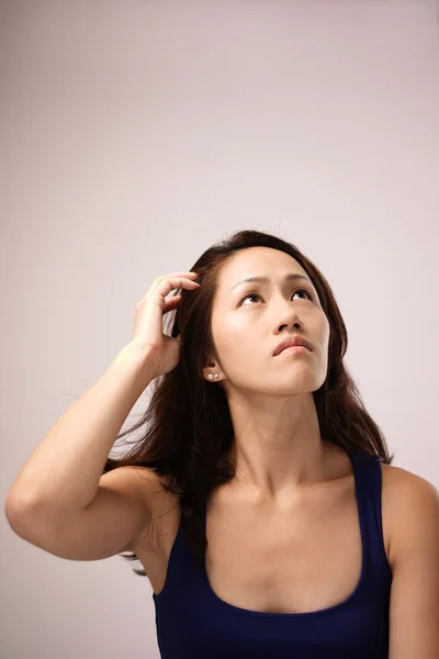 Asian chinese lady feeling puzzled — Stock Photo, Image