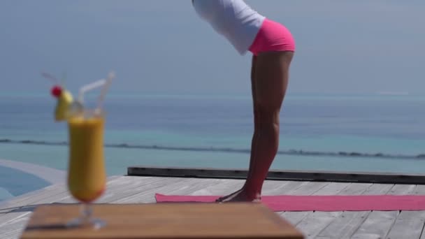 Asiática china practicando yoga junto a la piscina en Maldivas — Vídeos de Stock