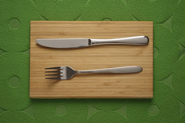 Modern Cutlery set on green fabric background — Stok Foto