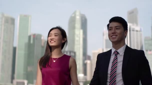 Asian couple walking slow motion from shade to sun — Stock Video