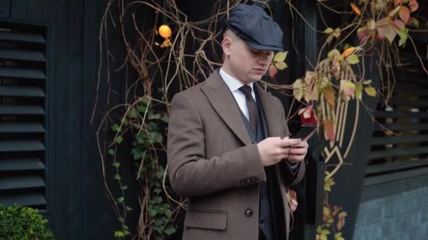 年轻时尚商人在街上用智能手机。一个男人在写字楼附近用智能手机发短信作弊生意。社交网络 — 图库视频影像