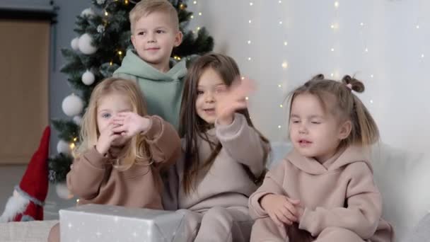 Çocuklar Hi 'yi Noel ağacının yanında gösteriyor. Çocuk konsepti için moda — Stok video