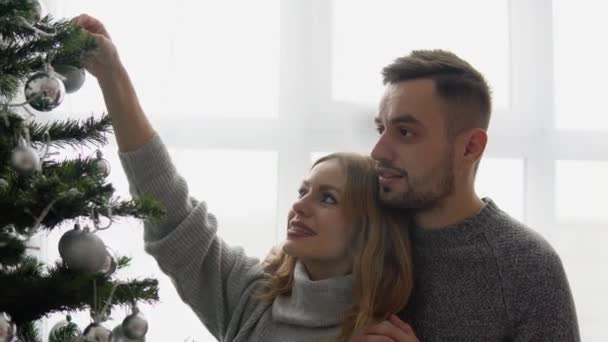 Couple decorating the Christmas tree together in the Christmas Eve — Stock Video