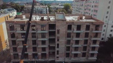 Aerial view of construction of a multi-storey apartment building. Construction crane
