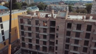 Aerial view of construction of a multi-storey apartment building. Construction crane
