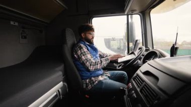 Takside oturup dizüstü bilgisayar üzerinde çalışan ciddi bir kamyon şoförü. Lojistik ve ulaşım sektörü profesyoneli onun güzergahını yönetiyor