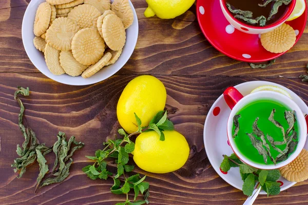 Fresh lemons, mint tea - green tea and tea cakes — Stock Photo, Image