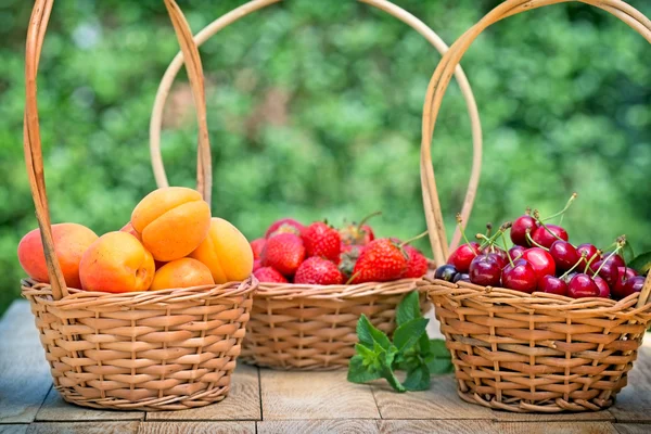 Frutos orgânicos frescos em cestas de vime — Fotografia de Stock