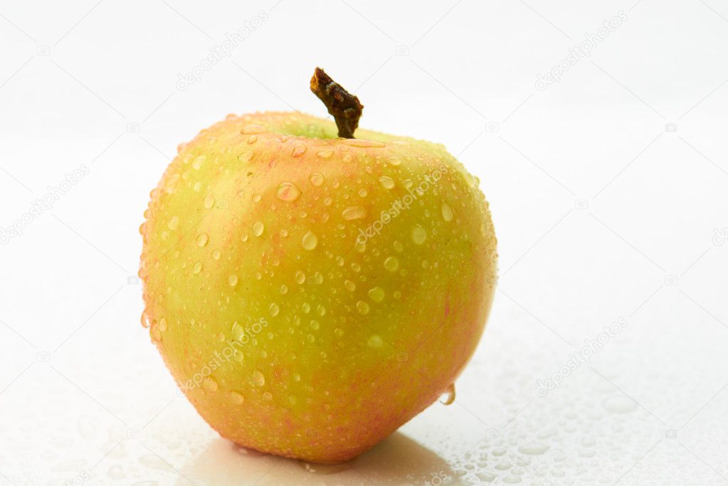 Yellow apple with droplet isolated on white