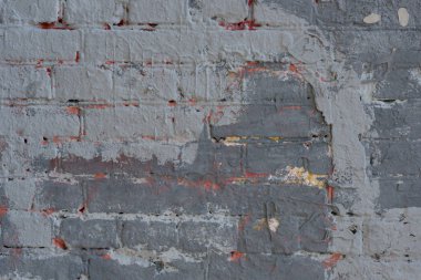 Boya izleri olan eski püskü bir duvar tuğlası.