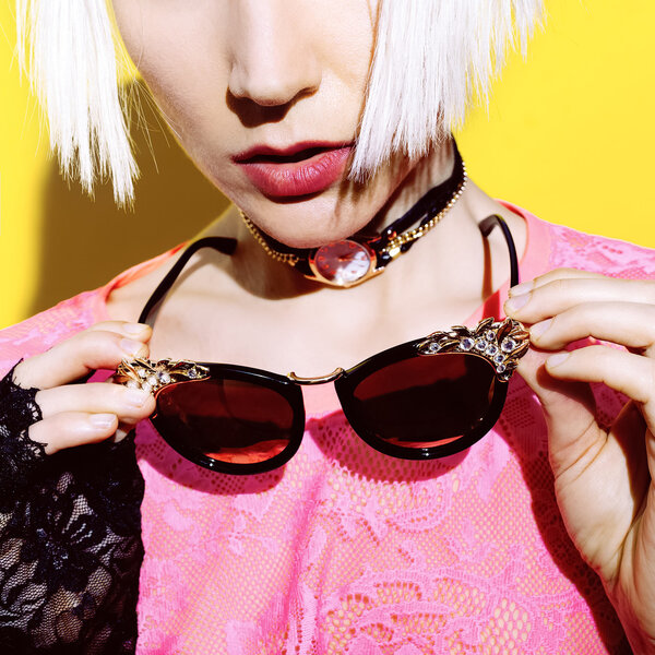 Blonde and fashion accessories. Sunglasses, necklace, glamorous 