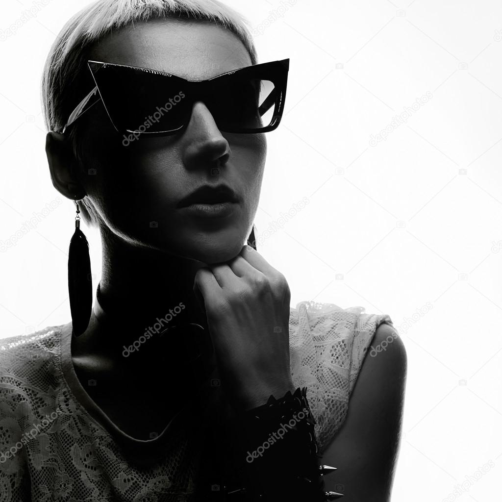 Sensual blond in trendy sunglasses and jewelry. Black and white 