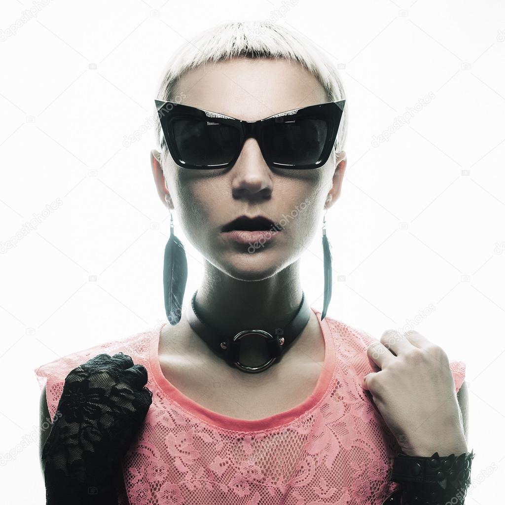 Fashion blond model in a stylish jewelry and sunglasses. Feel st