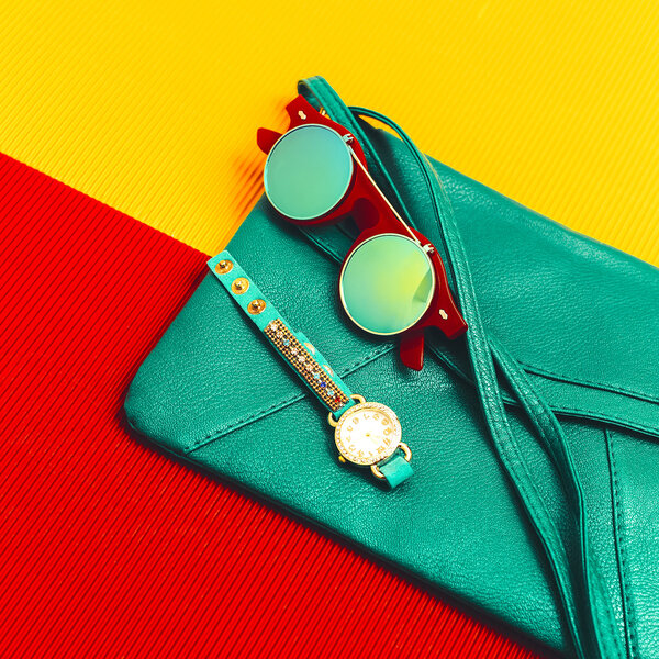 Stylish accessories. Green Leather Clutch, watches and sunglasse