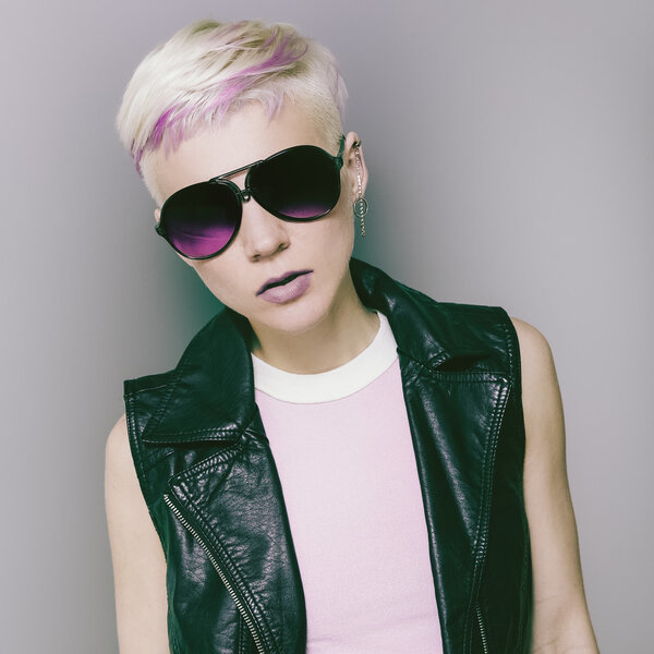 blonde with short hair and trendy sunglasses. Rock style