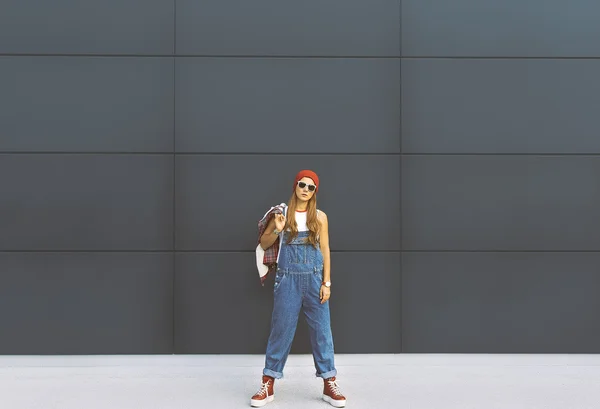 Girl student. In fashionable denim overalls. Urban Locations — Stock Photo, Image