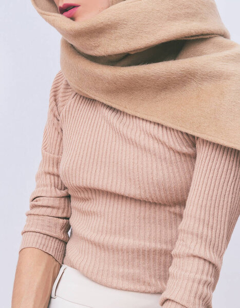 Stylish Details of everyday look.  Model wearing casual beige outfit.  Pullover and scarf. Trendy  Minimalistic style. Total Beige aesthetics. Fashion look book. Warm Fall Winter seasons concept