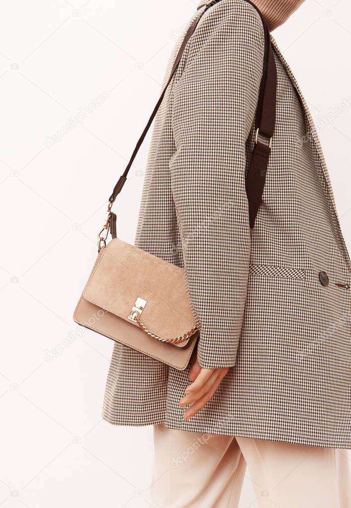 Stylish paris Lady. Details of everyday look. Casual beige checkered jacket and accessories velvet bag Trendy Minimalistic style. Fashion fall winter spring look book.