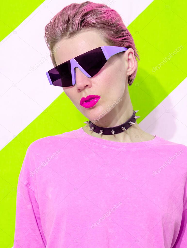 Acid Party Model with short hair wearing stylish accessories agressive choker and futuristic sunglasses. Trendy everyday street outfit in details
