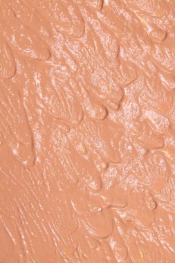 Bej rengi tonal fondöten dokusu krem duvar kağıdı lekesi. Makyaj ve cilt bakımı için kozmetik ürünleri